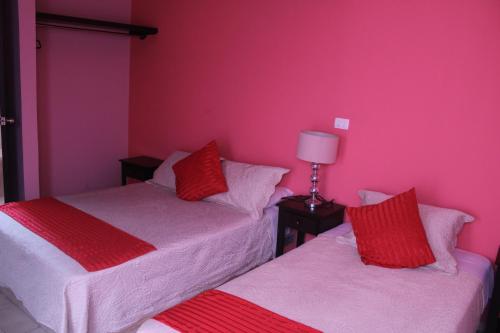 Postel nebo postele na pokoji v ubytování Hotel Boutique La Orquidea