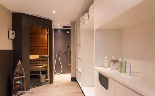 a bathroom with a shower and a counter with a sink at Chalet Alpinum in Sankt Anton am Arlberg
