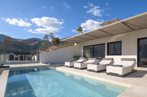 an image of a house with a swimming pool at Cueva Villas, with Pool, SeaViews & close to Sea, By ThinkVilla in Balíon