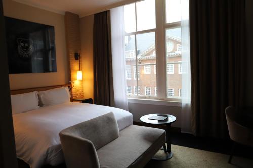 a hotel room with a bed and a window at Sofitel Legend The Grand Amsterdam in Amsterdam
