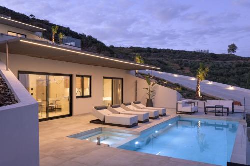 a house with a swimming pool in the backyard at Cueva Villas, with Pool, SeaViews & close to Sea, By ThinkVilla in Balíon