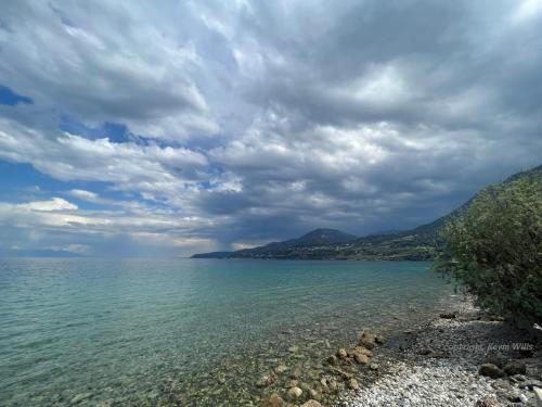 a large body of water under a cloudy sky at Panorama Hotel - Restaurant in Diakopto