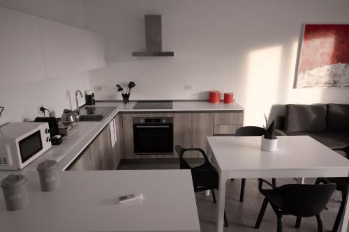 a kitchen with a counter and a table and a microwave at Casa Ferrari in Montale