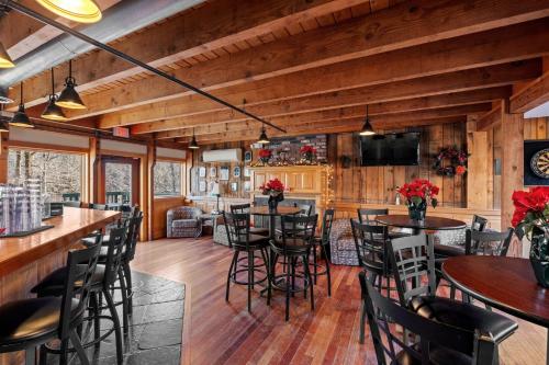 a dining room and kitchen with tables and chairs at Ski Home on Bell Valley in Campton