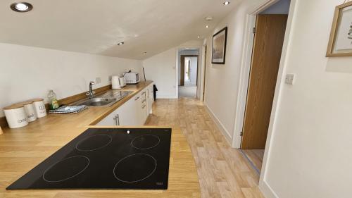 a kitchen with a sink and a counter at Stable Barn Apartment in Saint Breward