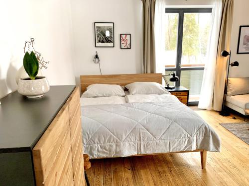 a bedroom with a large bed with a table at Apartment Loft Lomnica in Tatranská Lomnica