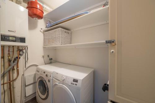 a laundry room with a washer and dryer at Meerzicht 71 - Perfectly suited for 6 persons in Uitgeest