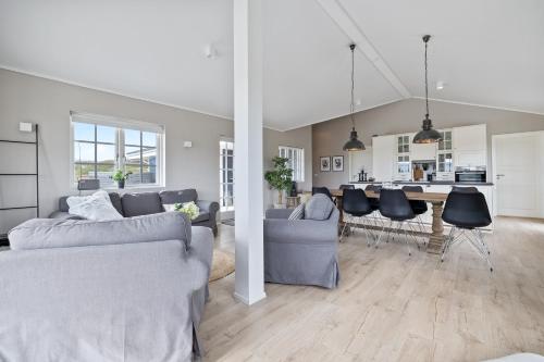 a living room with a couch and a table at Venture Vacations-Golden Circle Hot Tub Cabin in Selfoss