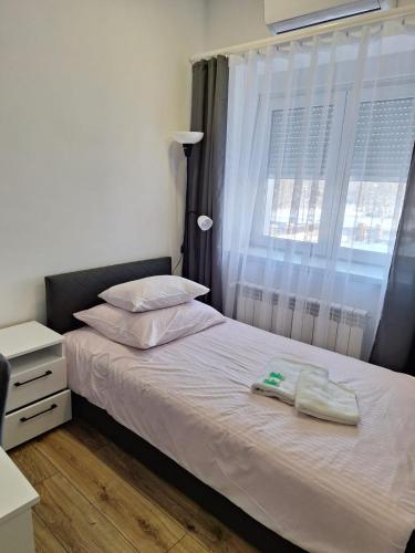 a bedroom with a bed and a window at Comfort Stay, EV, Parking in Bolesławiec
