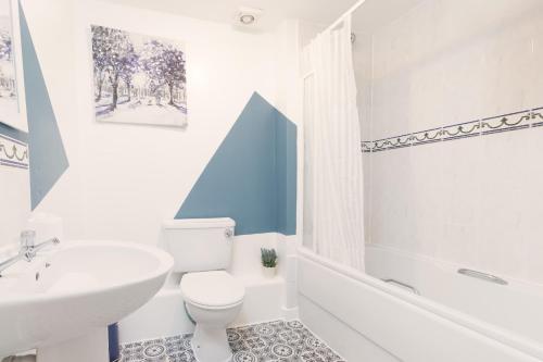 a bathroom with a white toilet and a sink at Comfy 2BR Apartment with Balcony - Waterlily in Coventry