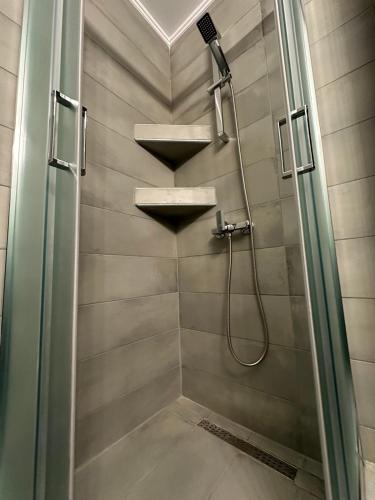 a bathroom with a shower with two sinks and a shower at Pension Karvounoskala in Stratoni
