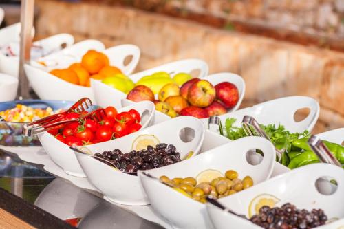 a bunch of bowls of fruits and vegetables on a table at Aquarius Hotel in Kas