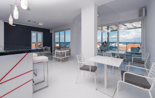 a kitchen and dining room with a table and chairs at Diana Hotel in Zakynthos Town