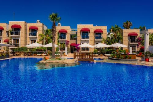 a large swimming pool in front of a hotel at Bodrium Hotel & Spa in Bodrum City