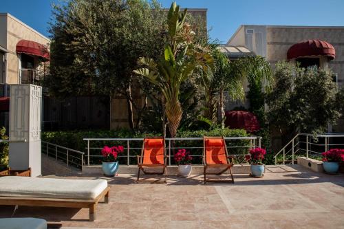 two chairs and a couch in a courtyard at Bodrium Hotel & Spa in Bodrum City