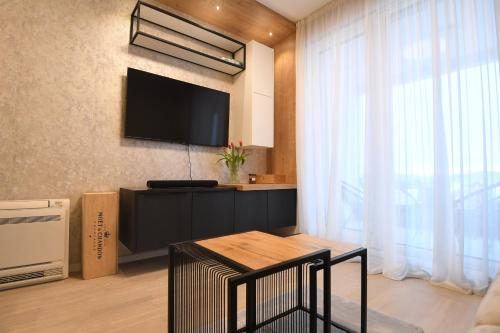 a living room with a flat screen tv on a wall at K&P - Zadar Luxurious Retreat - BRAND NEW !! in Zadar