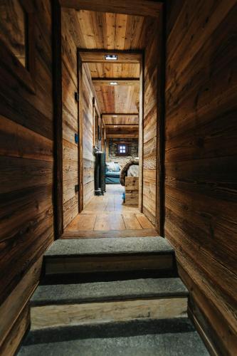 an empty hallway with wooden walls and wooden stairs at Chalet Cime Bianche in Breuil-Cervinia