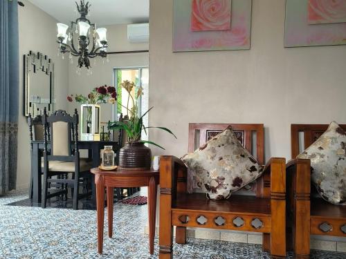 a living room with a couch and a table with pillows at Laman Zavilla Dhoma 2 in Bagan Lalang