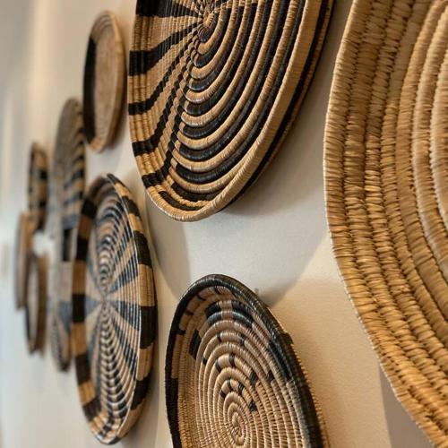 a bunch of baskets hanging on a wall at AH-10 - Luxury 3 BR Beach Apartment in typical island village by Althea in Pointe aux Piments