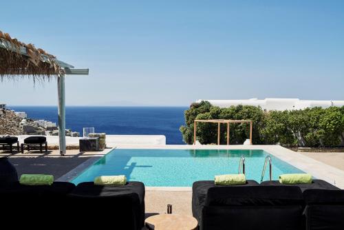 a swimming pool with a view of the ocean at Myconian Villa Collection - Preferred Hotels & Resorts in Elia Beach