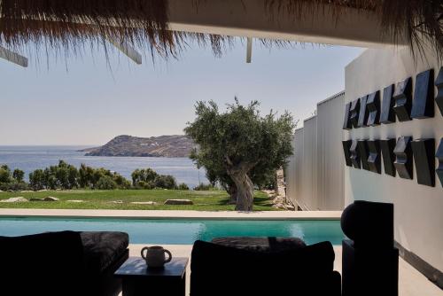 a villa with a pool and a view of the ocean at Myconian Villa Collection - Preferred Hotels & Resorts in Elia Beach