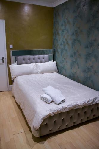 a large bed with two towels on top of it at *NEW* Chic Guest Suite - Nr Wembley stadium in London