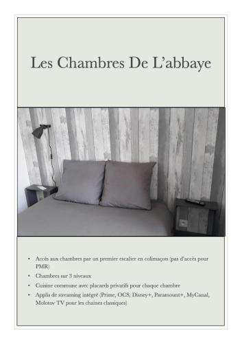 a page of a flyer with a bed with a pillow at Les chambres de l'Abbaye in Fécamp
