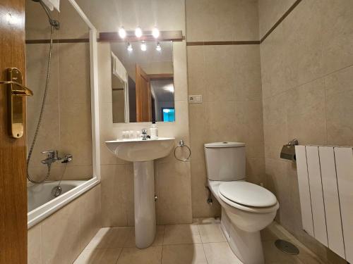 a bathroom with a toilet and a sink and a shower at 24A03 Apartamento en plena naturaleza en Arenas de Cabrales in Arenas de Cabrales