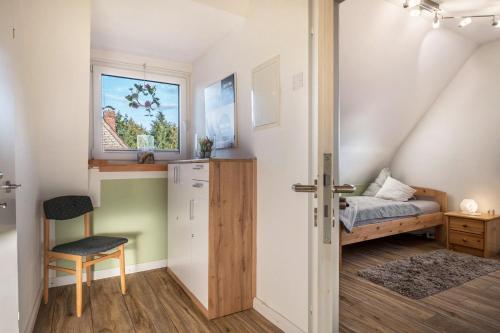 a small bedroom with a bed and a window at Haus Heidorn in Sittensen