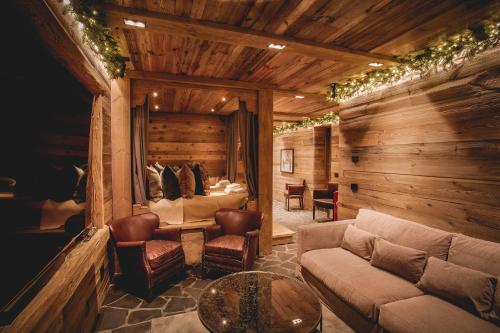a living room with a couch and a table at Chalet Cime Bianche in Breuil-Cervinia