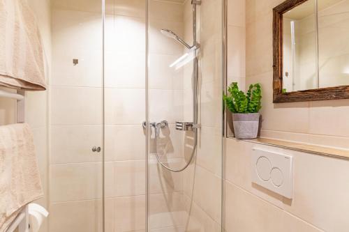 a shower with a glass door in a bathroom at Ferienwohnung Zugspitzblick in Farchant