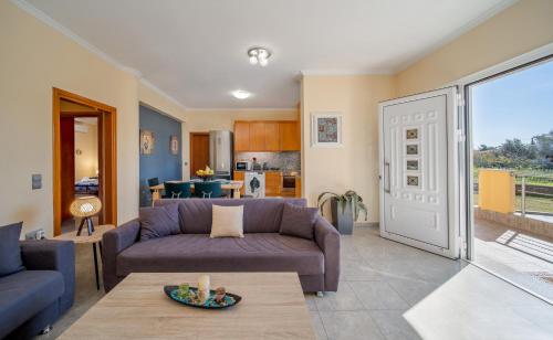 a living room with a couch and a table at Katerina Apartment in Afantou