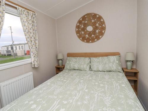a bedroom with a bed and a window at The Moon in Morecambe