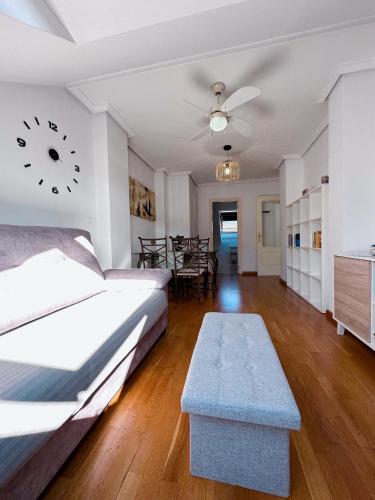a bedroom with a bed and a table and a clock at Alianza del Castillo in Ponferrada