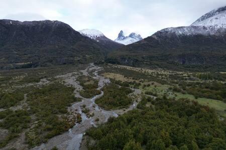 an aerial view of a river in a mountain valley at OUTSCAPE l Cabaña Familiar en mejor sector de Cerro Castillo in Villa Cerro Castillo