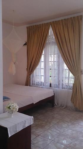 Ένα ή περισσότερα κρεβάτια σε δωμάτιο στο Welcome Family Guest House.