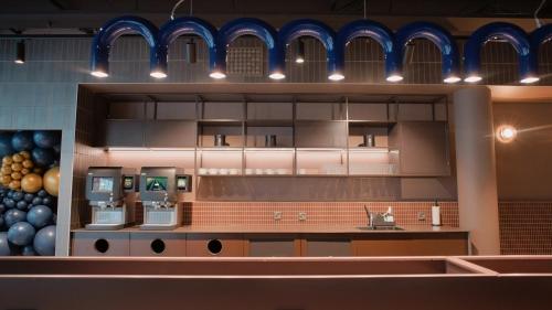 a kitchen with a sink and a counter with machines at Citybox Helsinki in Helsinki