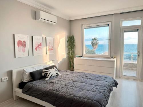 a bedroom with a bed with a view of the ocean at Cleopatra Beach l Truly Unique Sea View in Alanya