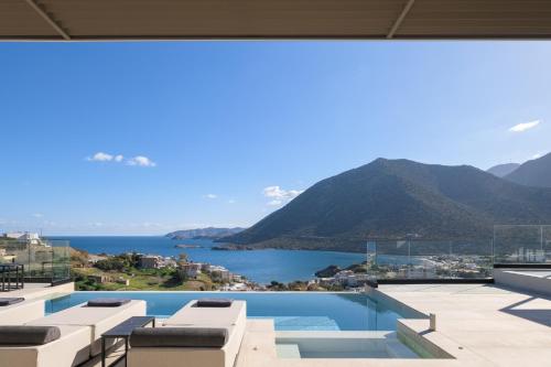 a view of the ocean from the balcony of a house at Cueva Villas, with Pool, SeaViews & close to Sea, By ThinkVilla in Balíon