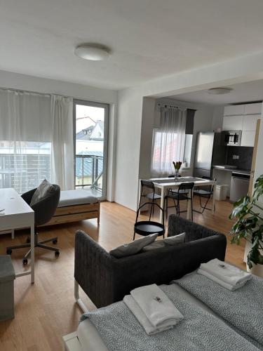 a living room with a couch and a dining room at Apartmán ERUDITO XXVI centrum Jihlava in Jihlava