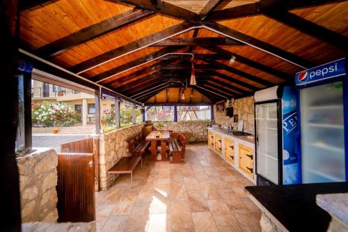 a large kitchen with wooden ceilings and a table at Complex Route 66 in Vama Veche