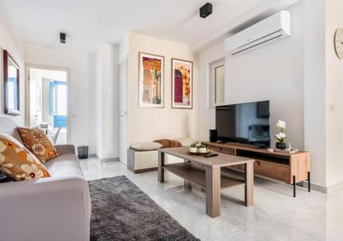 a living room with a couch and a table at Sea View Luxury Apartment Brand New in Valletta in Valletta