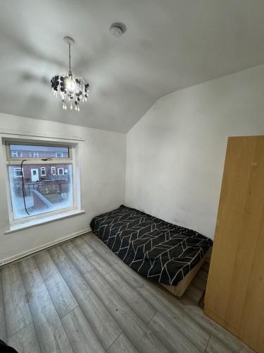 a bedroom with a bed in a room with a window at 34 Green Arbour Road in Brampton en le Morthen