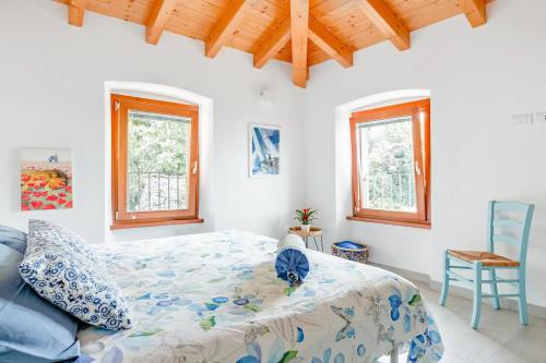 een slaapkamer met een bed en 2 ramen bij Ca de l'Angelon in Brenzone sul Garda