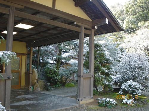 a pavilion in a garden with flowers and trees at Sansuien in Yamaguchi