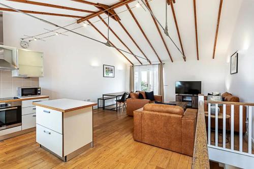 a kitchen and living room with a couch and a table at 2BR, Gated parking, 50" TV, Nespresso machine in London