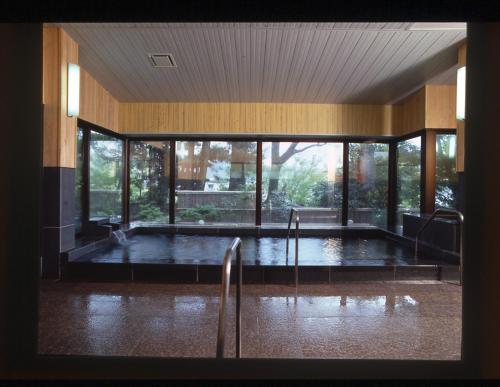 a room with a pool of water in a building at Sansuien in Yamaguchi