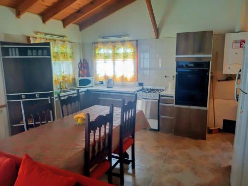 a kitchen with a table and a kitchen with a stove at BetiUSH in Ushuaia