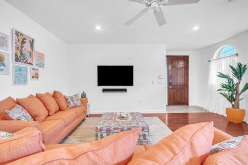 a living room with a couch and a flat screen tv at Center Grove - Lush & Spacious & New - 3 Bedrooms in Miami