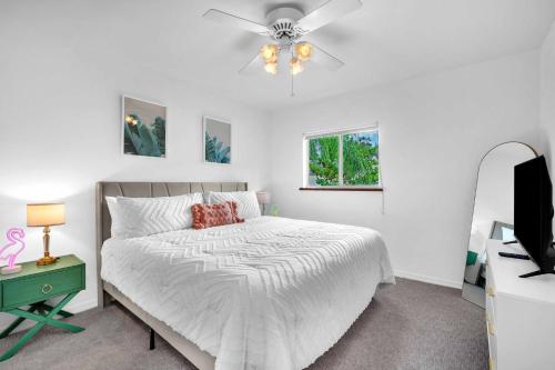 a white bedroom with a bed and a ceiling fan at Center Grove - Lush & Spacious & New - 3 Bedrooms in Miami